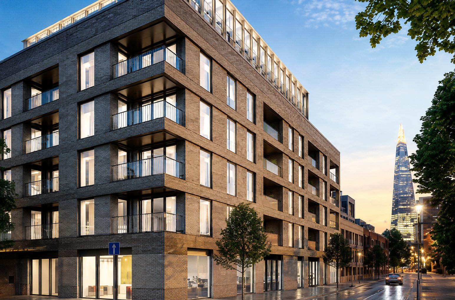 Design visualisation of Trilogy's brick corner block at dusk, with balconies above Harper Road and the Shard beyond